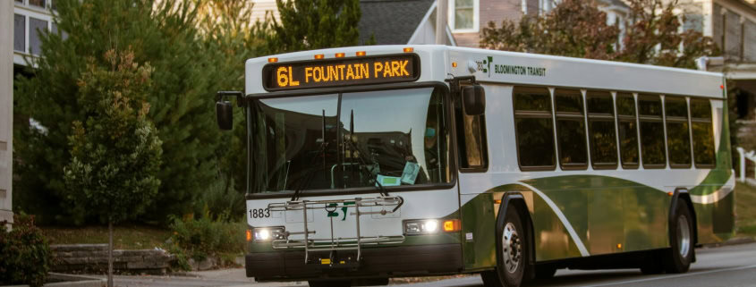 white and green bus on road during daytime